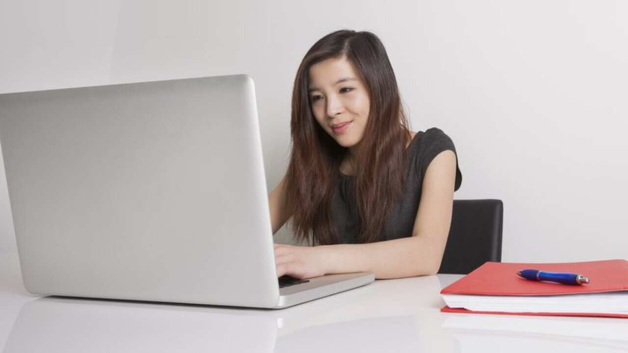 A businesswoman using laptop at office desk