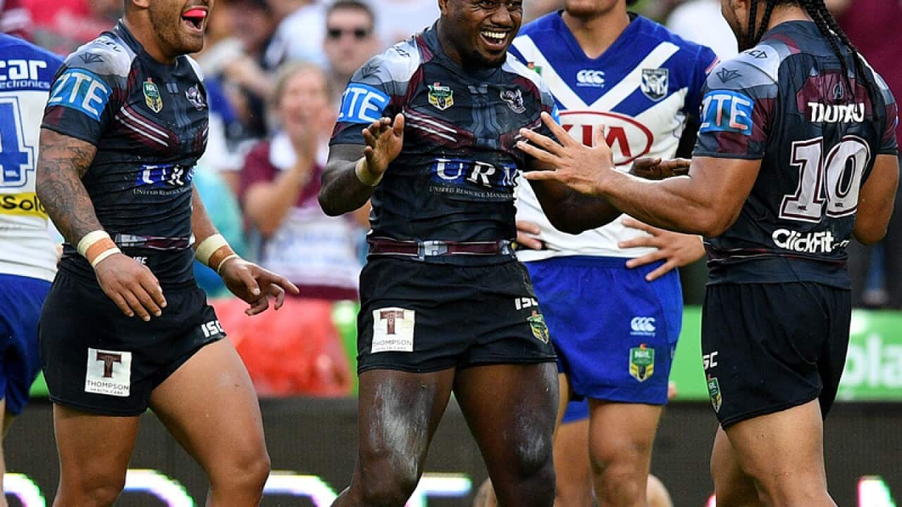 Akuila Uate of the Sea Eagles, (centre), celebrates