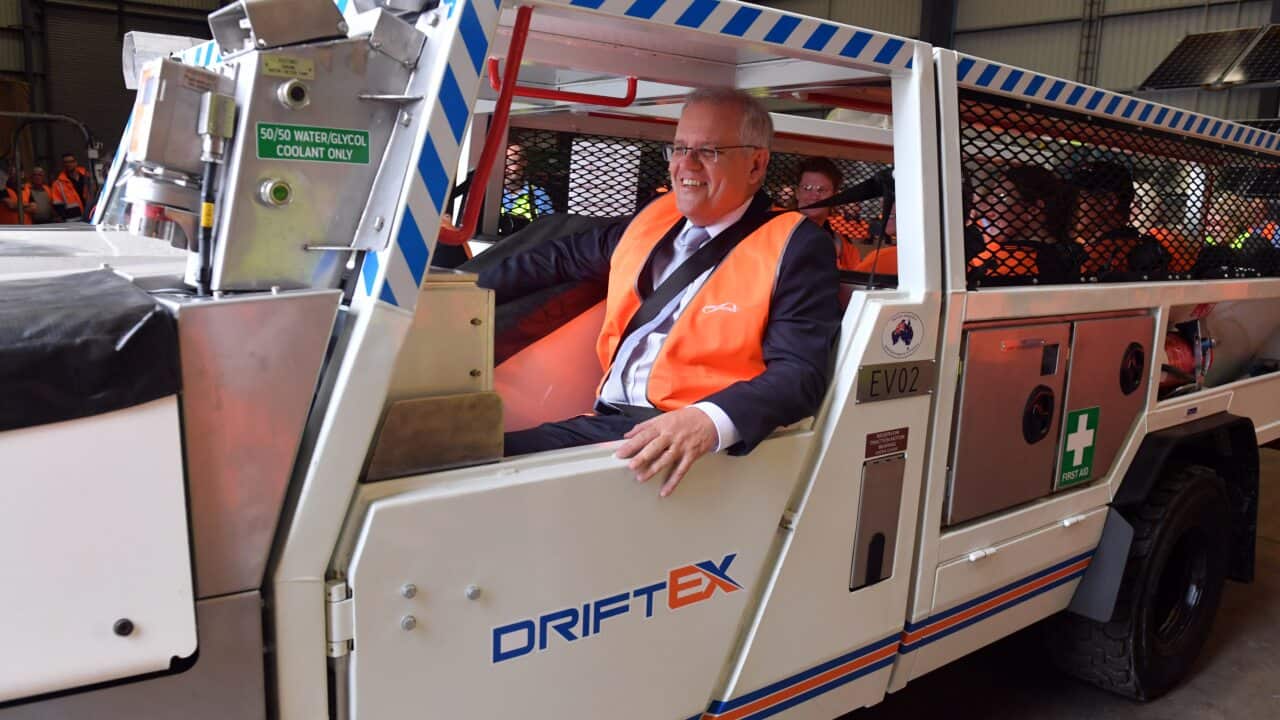 Prime Minister Scott Morrison inside an electric vehicle at an engineering facility specialising in renewable technology during a visit to the Hunter Valley.