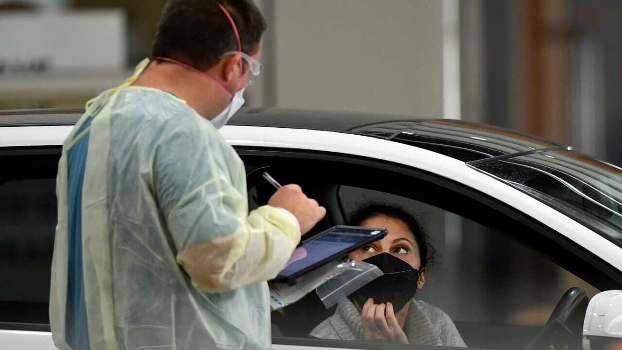 Members of the public are tested for COVID-19 at a drive-though testing centre in Melbourne