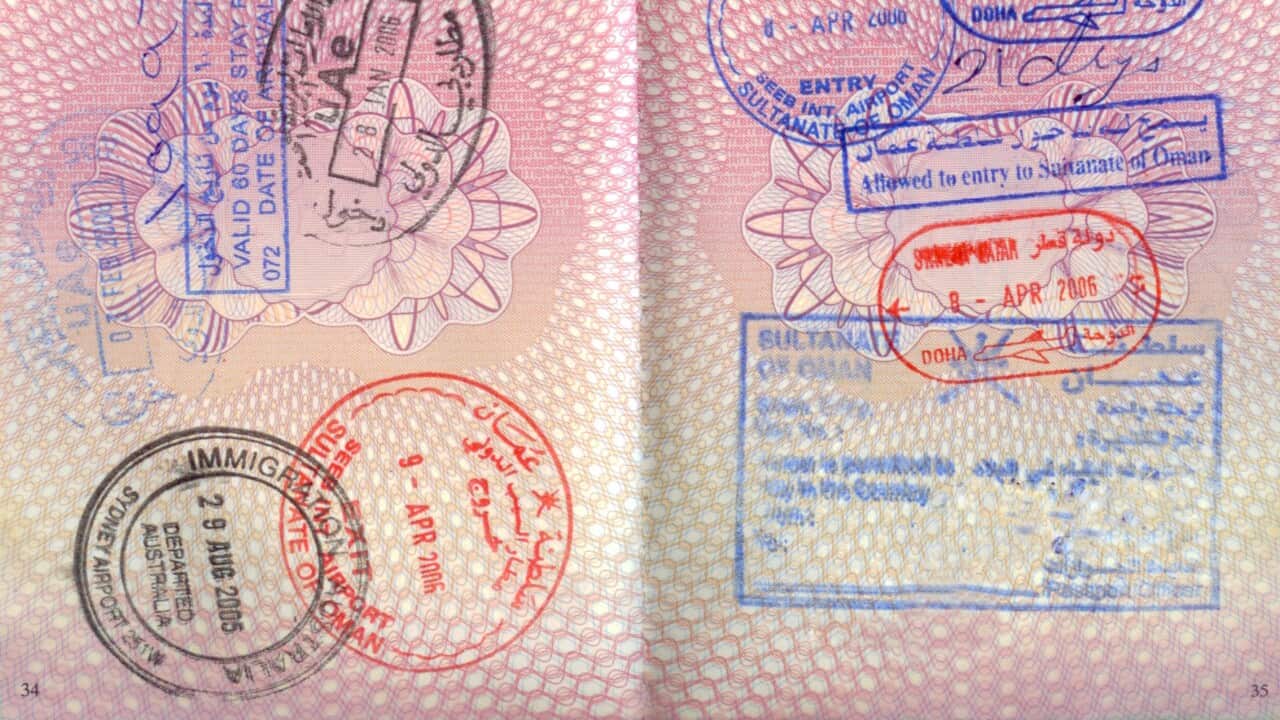 An opened passport with entry stamps on both pages