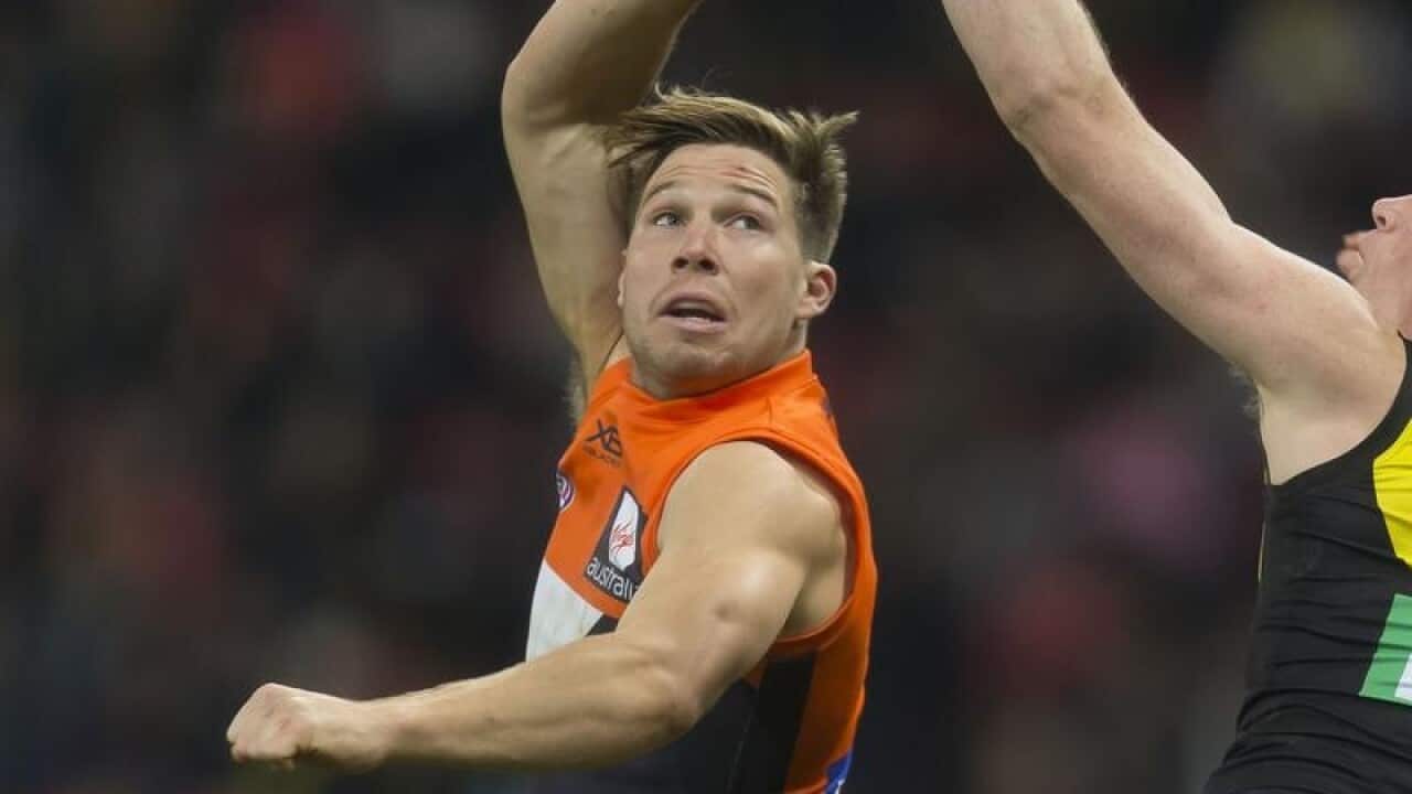 Toby Greene of the Giants and Dylan Grimes of the Tigers in action.