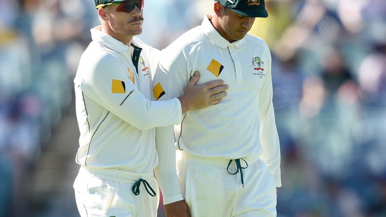 David Warner consoles Usman Khawaja as he leaves the field