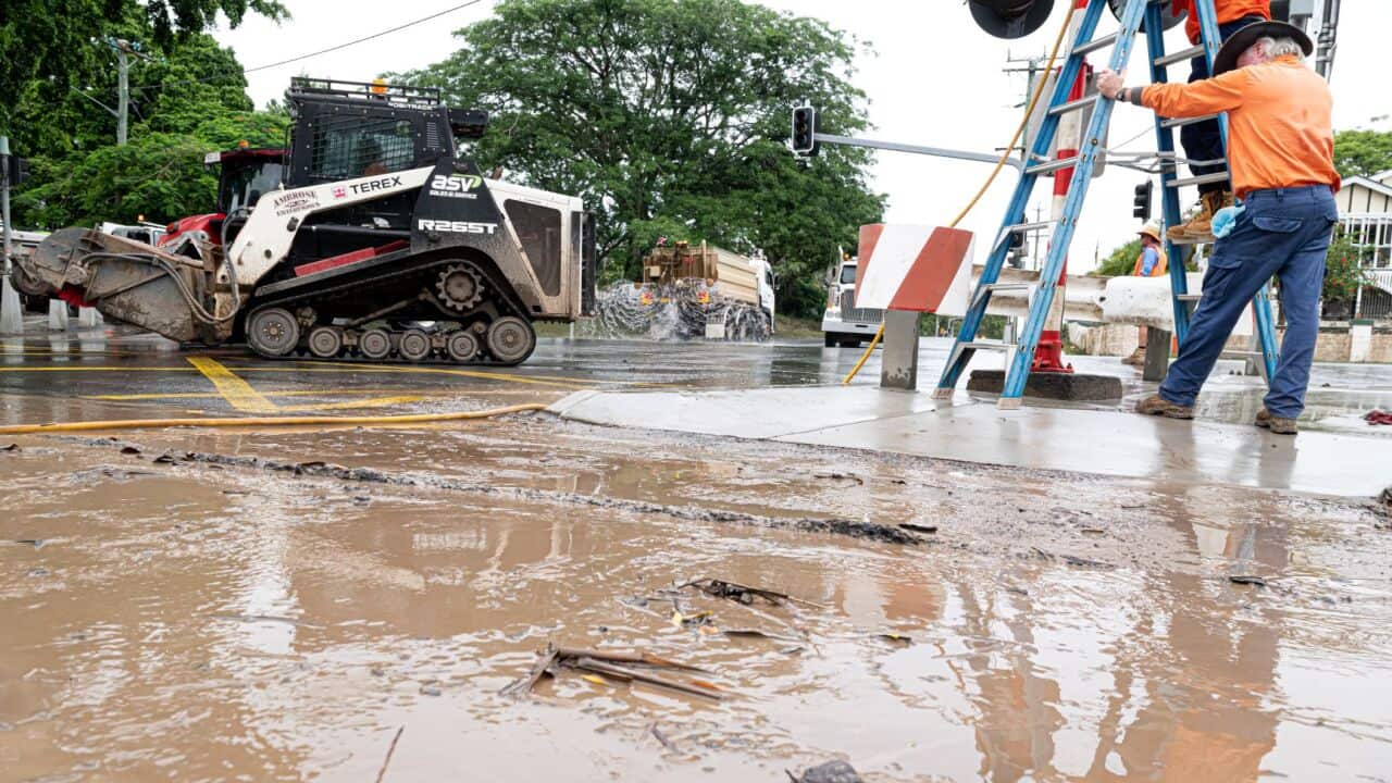 Council workers clean up damage caused by floodwaters in Maryborough, 220 km north of Brisbane