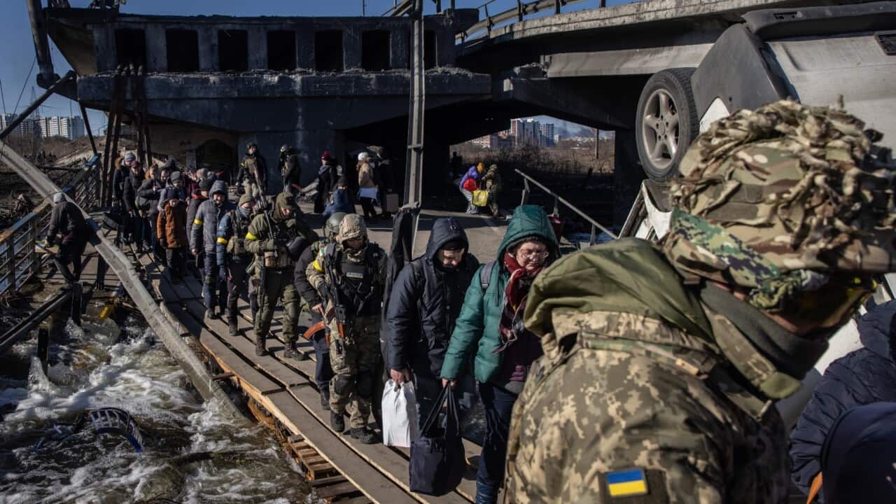 IRPIN, UKRAINE - MARCH 10: Residents of Irpin and Bucha flee fighting via a destroyed bridge on March 10, 2022 in Irpin, Ukraine.