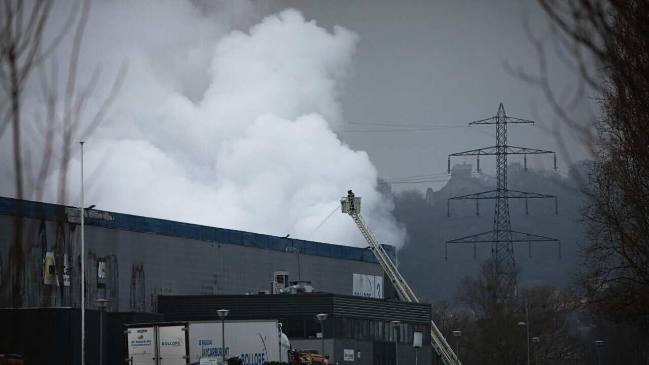 Firefighters spray water after lithium batteries caught fire at a French factory (Getty).