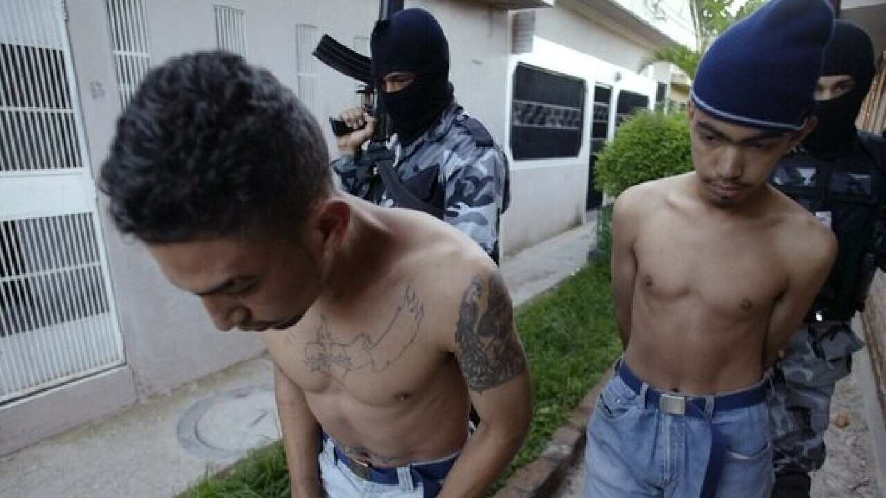 Honduran police escort two members of the street gang Mara 18.