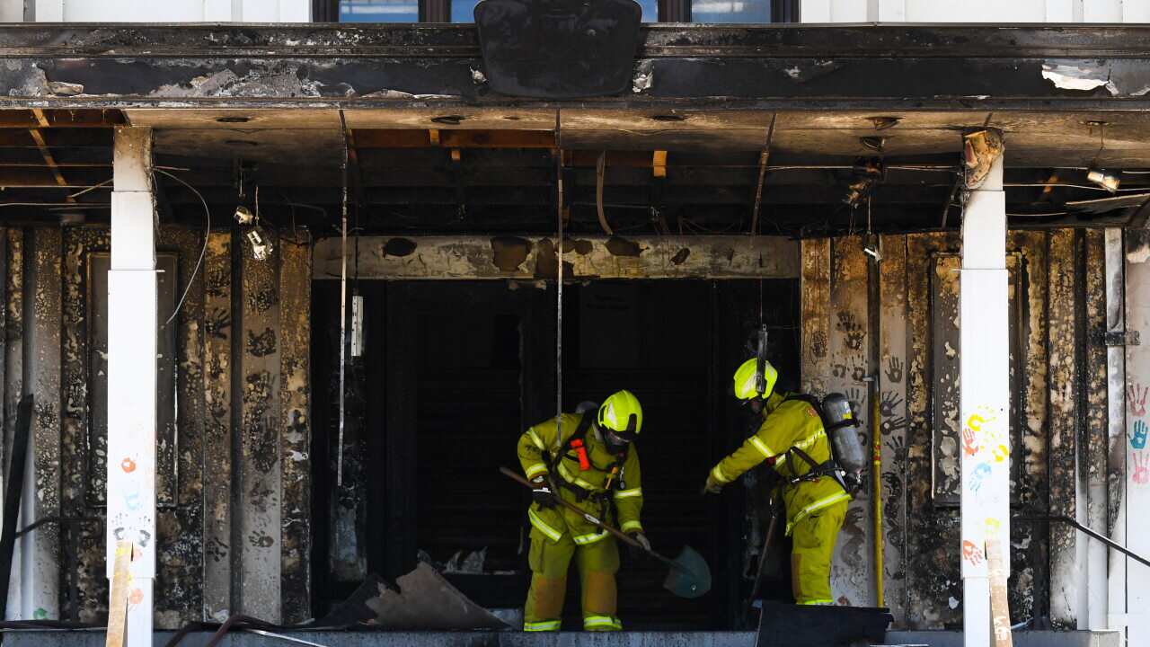 Firefighters are seen entering the fire damaged entrance to Old Parliament House in Canberra