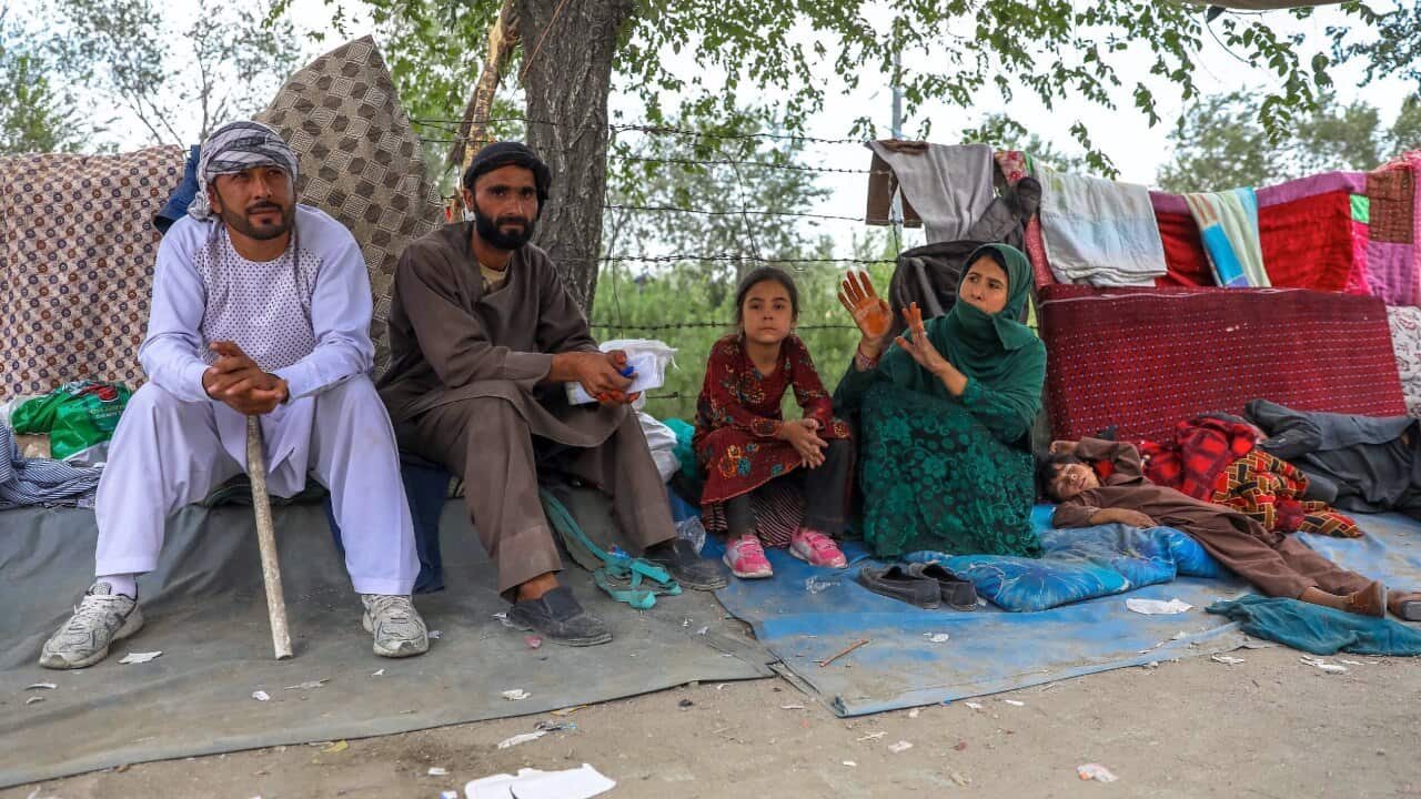 Families who fled fighting in Afghanistan's northern provinces shelter in a public park in Kabul, Afghanistan on 14 August 2021.