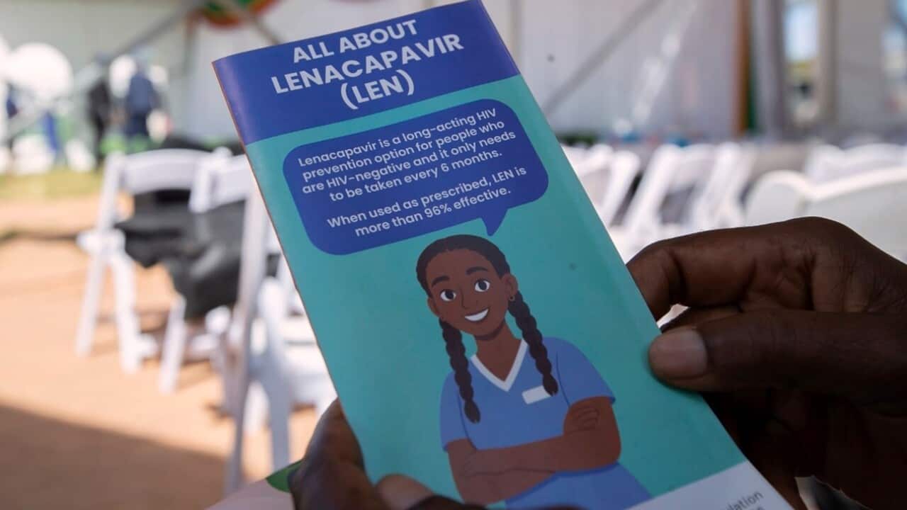A woman holds an informational pamphlet on lenacapavir in Zimbabwe.jpg
