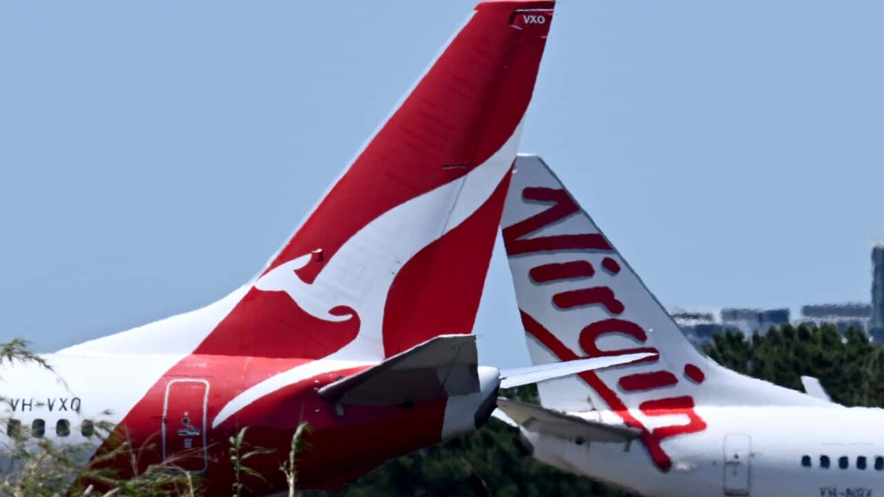 The tails of Qantas and Virgin airline planes
