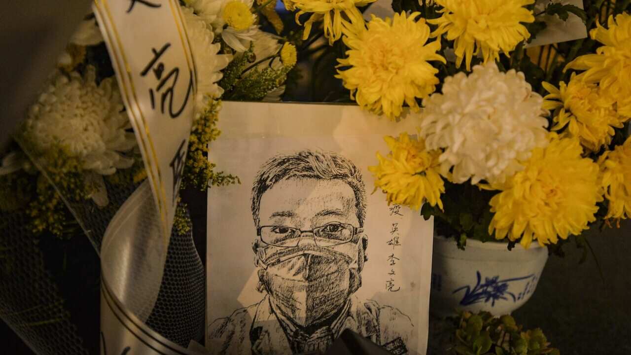 A card with a portrait of Li Wenliang outside a hospital in Wuhan in central China's Hubei province, 7 February 2020