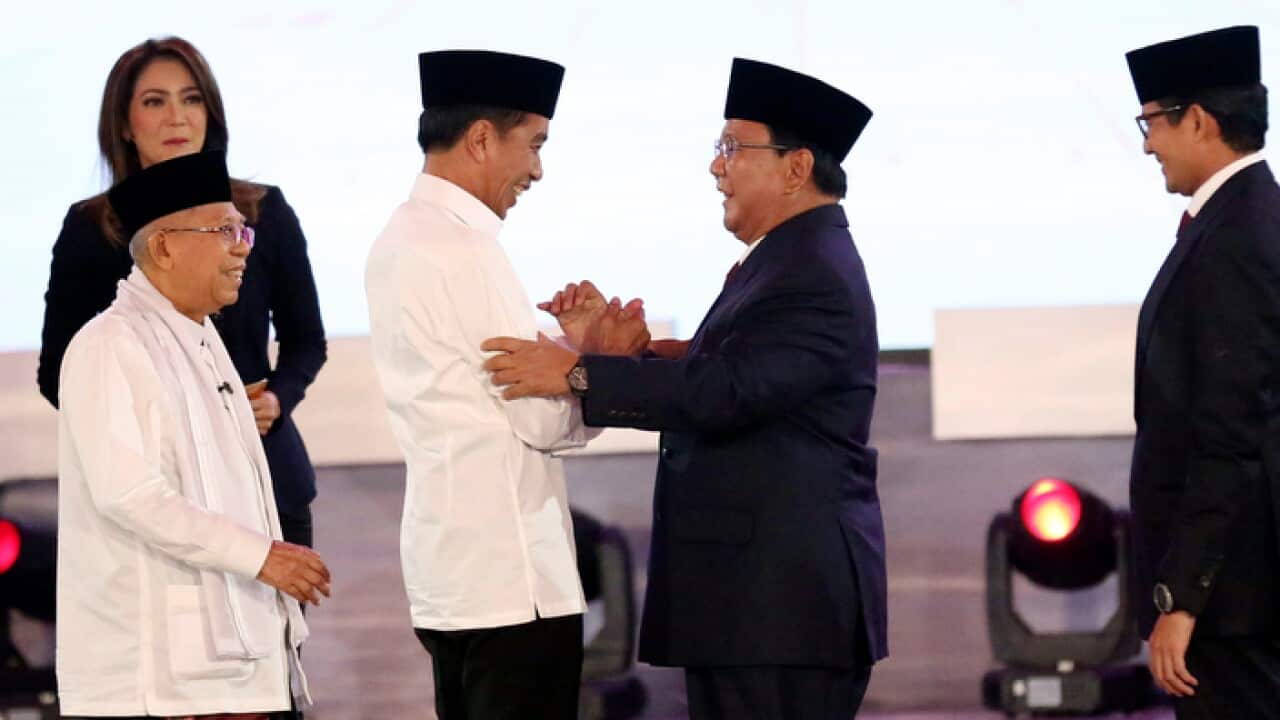 President Joko Widodo and contender Prabowo Subianto shake hands after TV debate