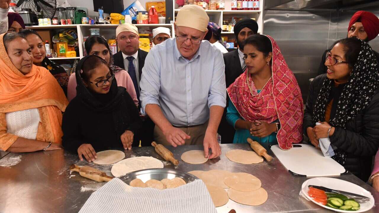 Prime Minister Scott Morrison makes roti bread at a Gurdwara Siri Guru Nanak Darbar Sikh Temple in Pakenham in Melbourne on 14 May 2022.