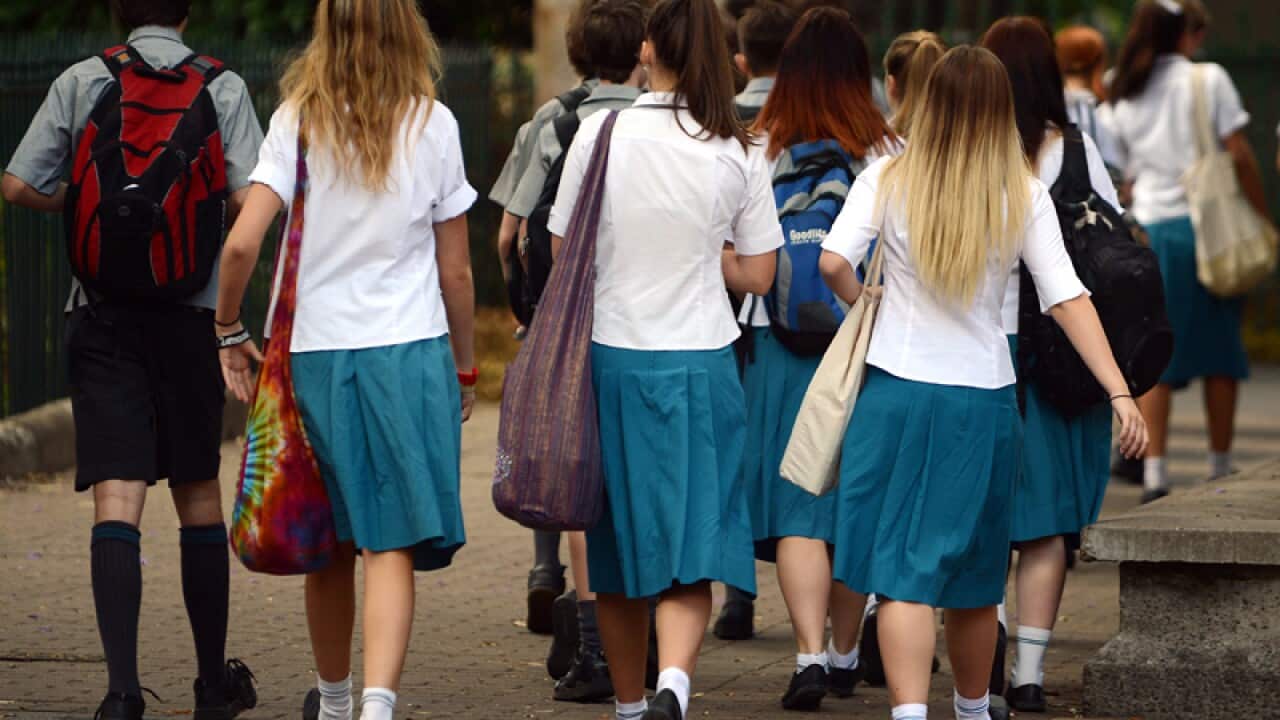 A group of high school students walk together during a school excursion in Brisbane, Friday, Nov. 1, 2013. (AAP Image/Dan Peled) NO ARCHIVING