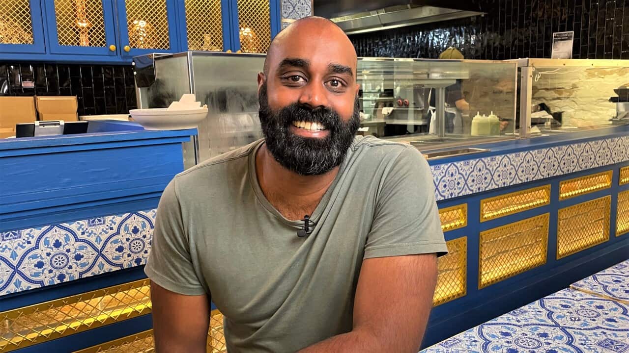 Kabul Social founder Shaun Christie-David facing camera sitting at a table.