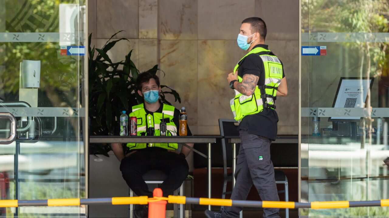 Security guards are seen at the Four Points Sheraton hotel in Perth, Sunday, 31 January, 2021.