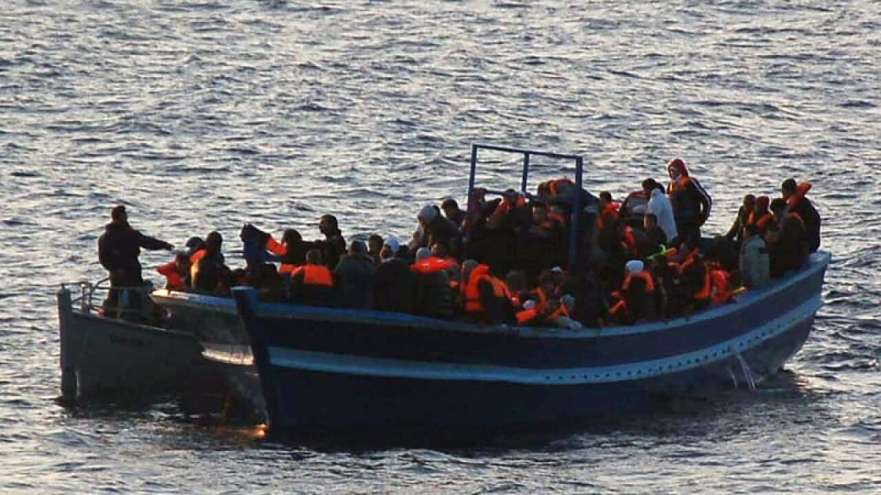 Migrants standing on a boat during a rescue operation