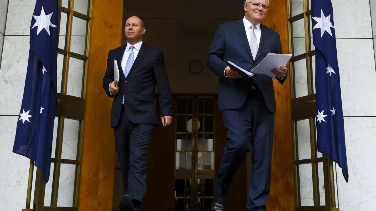Australian Prime Minister Scott Morrison (right) and Australian Treasurer Josh Frydenberg arrive for a press conference at Parliament House in Canberra, Thursday, March 18, 2021. (AAP Image/Lukas Coch) NO ARCHIVING