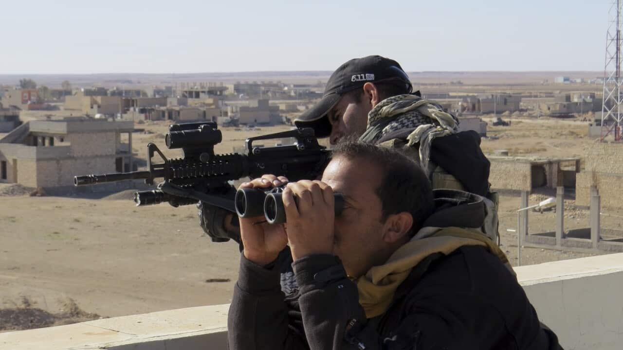 In this Nov. 14, 2015, file photo, soldiers of Iraq anti-terrorism forces watch movements during a military operation to regain control of the western suburbs of Ramadi, the capital of Iraq's Anbar province.
