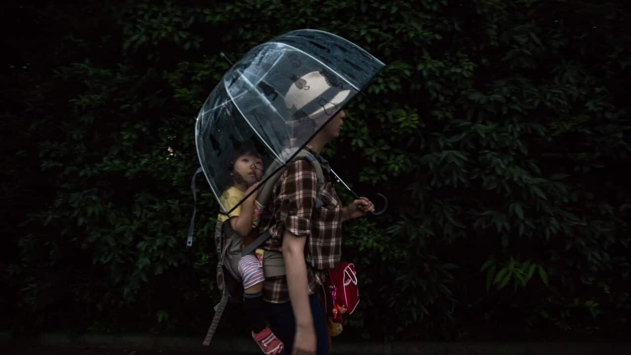 Erica Takato and her daughter, Saya, walk back from nursery school together, in Tokyo.
