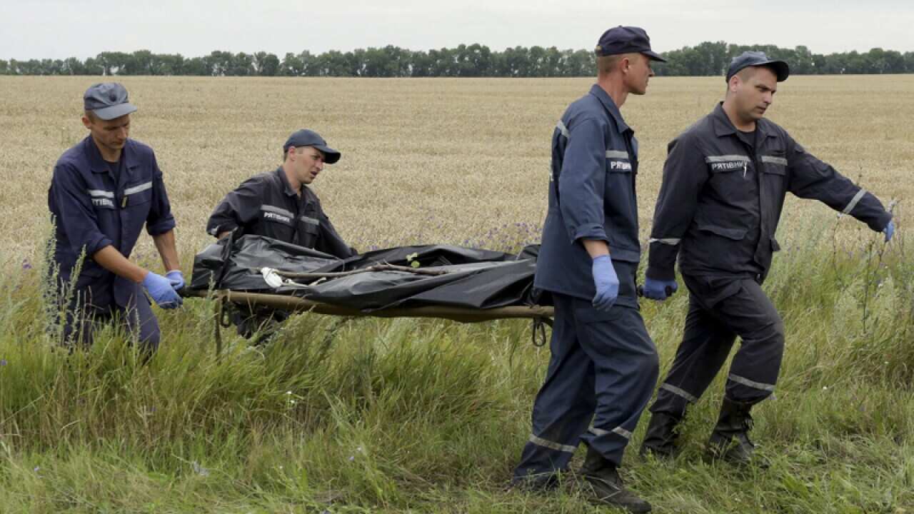 Rescuers carry bodies of passengers on a stretcher
