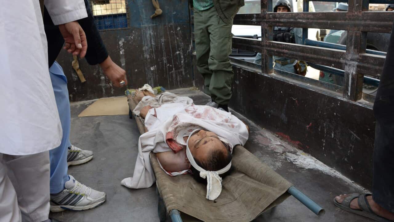 The body of an Afghan civilian killed in a bomb attack lies in the back of a vehicle in Kabul on October 9,2015. At least one civilian killed and three others wounded in magnetic bombs explosions placed inside a Shiite mosque in downtown Kabul. (AFP)