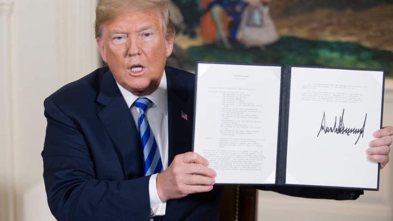 US president Donald Trump holds a national-security memorandum he has signed (AAP) 704