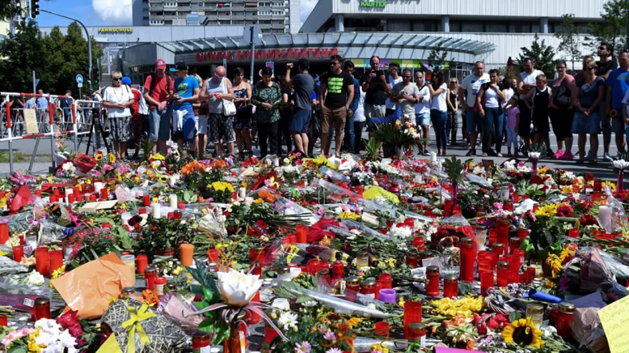 flowers lie outside the Olympia shopping center