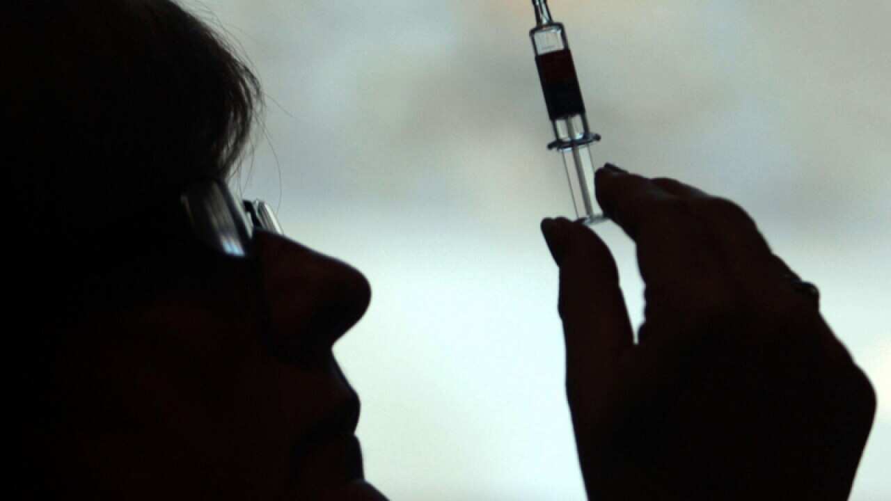 A nurse preparing to give a patient an injection