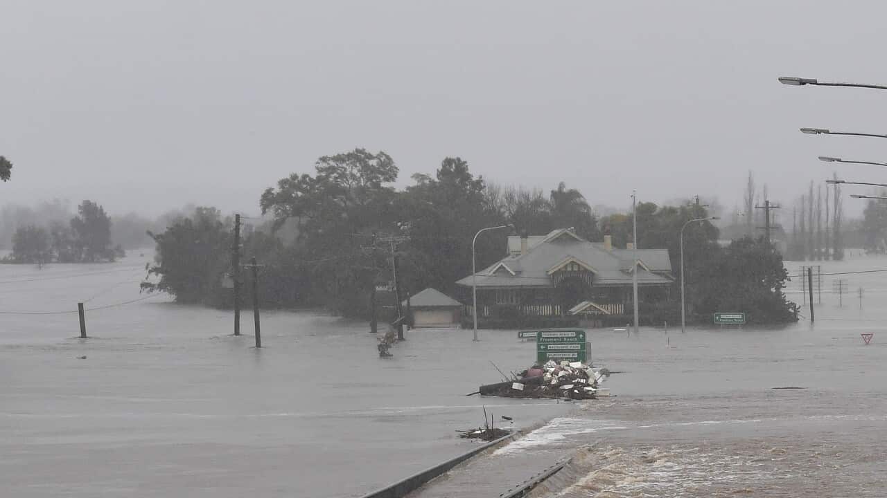 NSW Fire and Rescue look on as the Windsor Bridge is submerged under floodwater from the swollen Hawkesbury River, in Windsor, north west of Sydney, Monday, July 4, 2022.