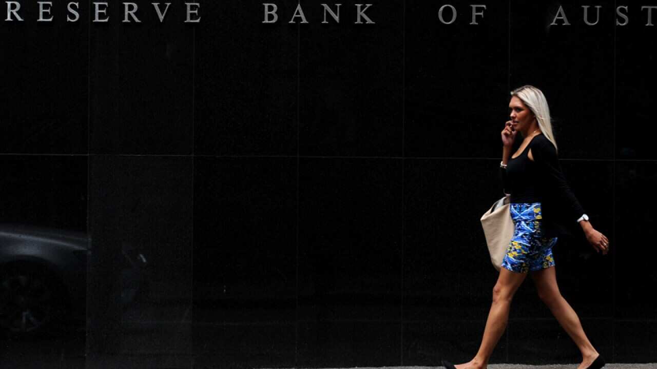 A pedestrian walks past the Reserve Bank of Australia headquarters