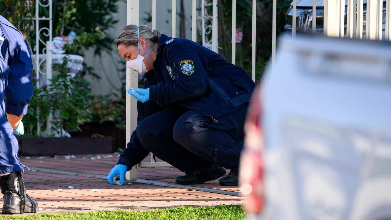 NSW Police and forensics establish a crime scene outside a home.