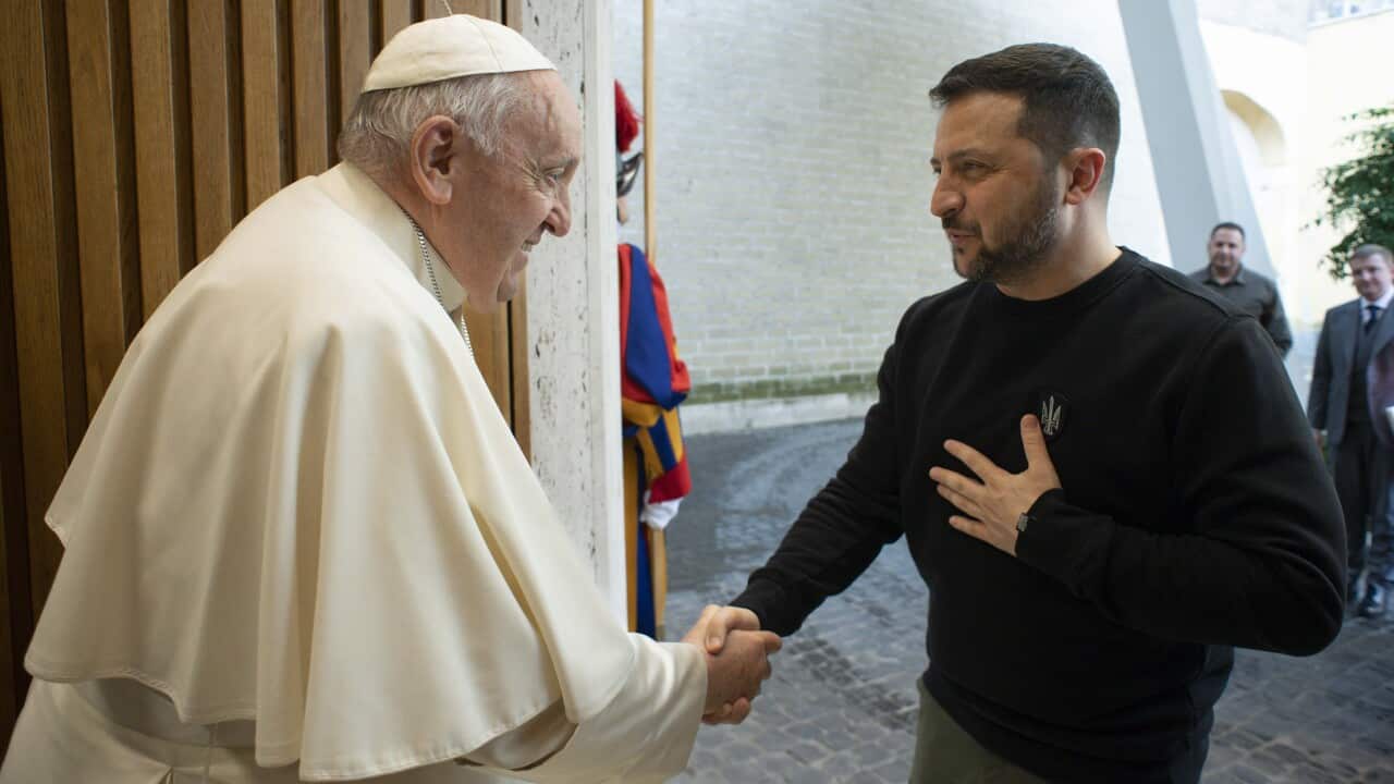 Pope Francis shakes hands with Ukrainian President Volodymyr Zelenskyy.