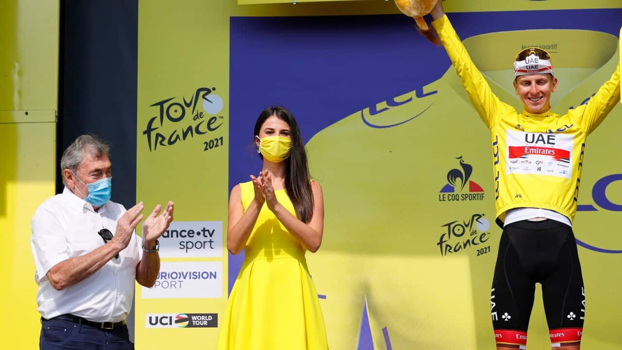 Eddy Merckx (L) looks on as Tadej Pogacar wears the yellow jersey at the Tour de France.