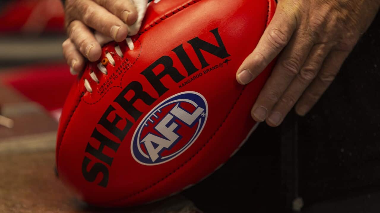 Staff work on the production of Sherrin footballs to be used in the 2019 AFLW Grand Final, at the Sherrin Factory in Scoresby, Melbourne, Thursday, March 28, 2019. (AAP Image/Daniel Pockett) NO ARCHIVING, EDITORIAL USE ONLY