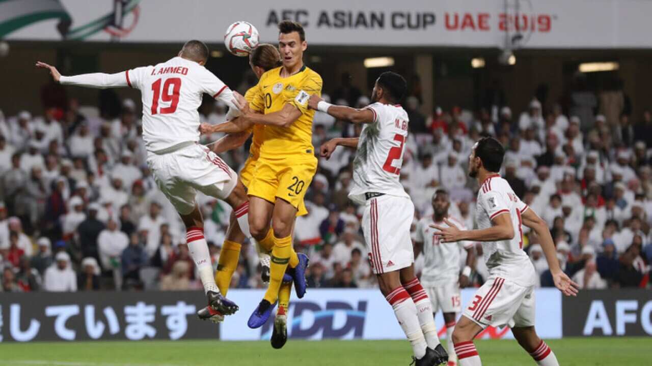 Ismail Ahmed Mohamed of UAE and Trent Sainsbury of Australia battle for possession in the air