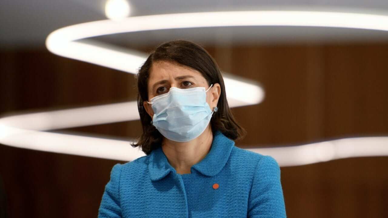 NSW Premier Gladys Berejiklian watches on during a press conference in Sydney