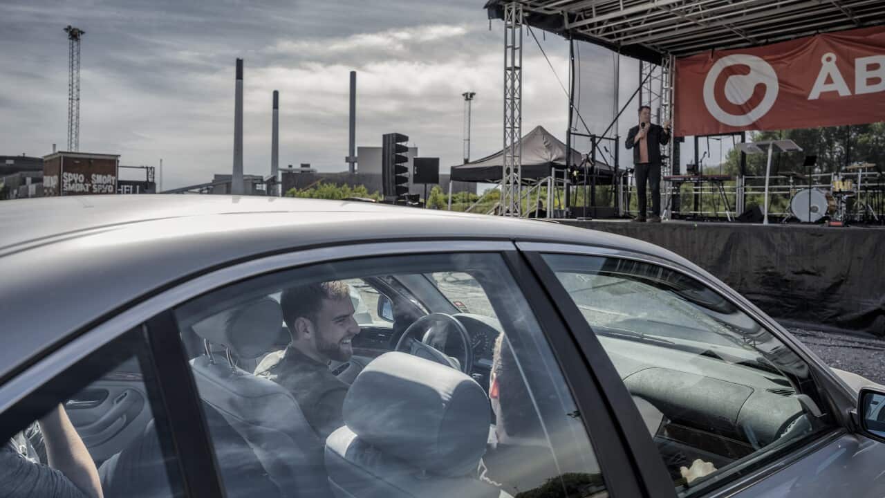 Thomas Christensen, on stage, speaks to congregants at a drive-in church at an industrial wasteland in eastern Copenhagen, May 31, 2020.