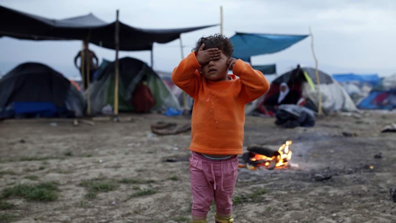 A migrant child posies for photo