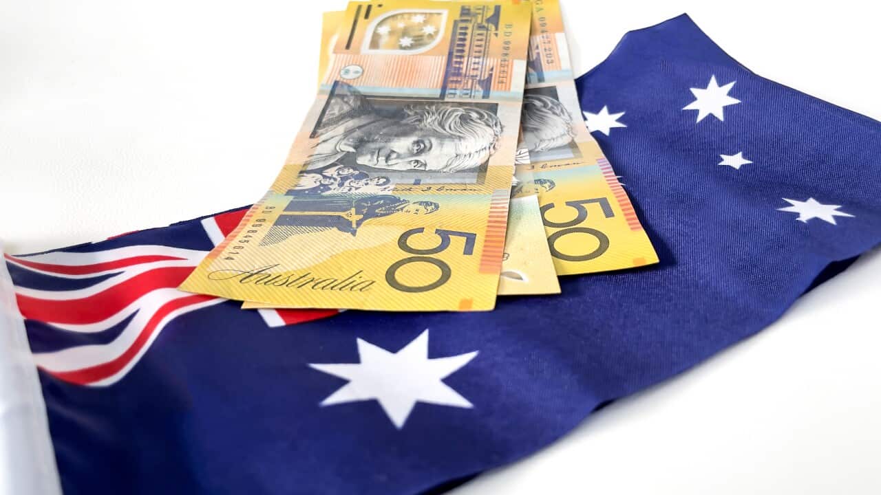 Australian dollars cash on the Australian national flag as a background. Fifty dollars notes cash. Economy and investment concept money