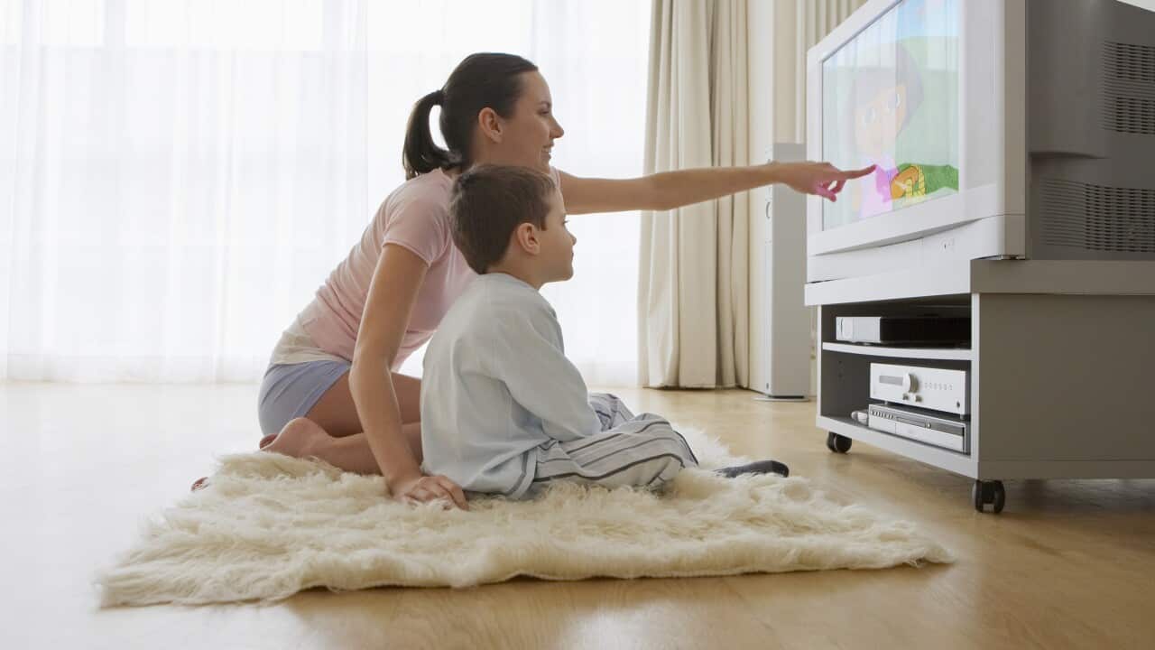Mother and son watching TV. (AAP)