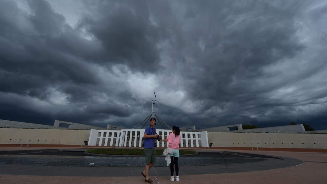 People standing in front of Parliament House in Canberra.