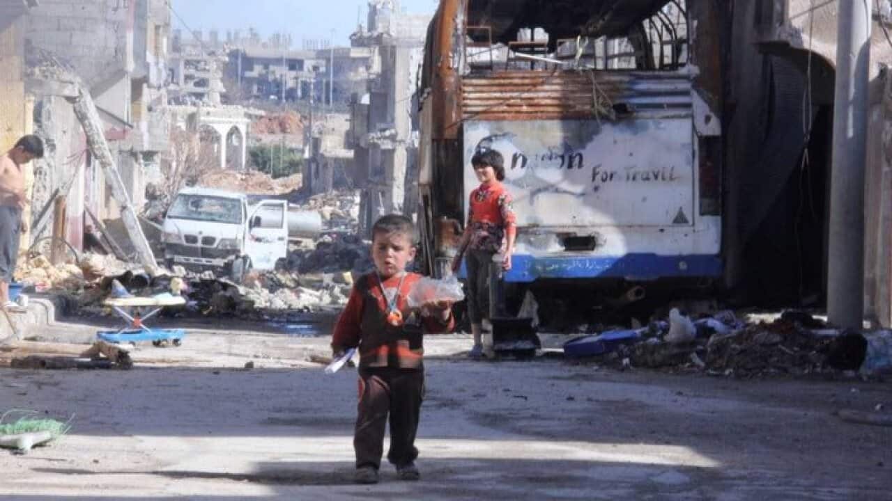 little boy in damaged Kobani