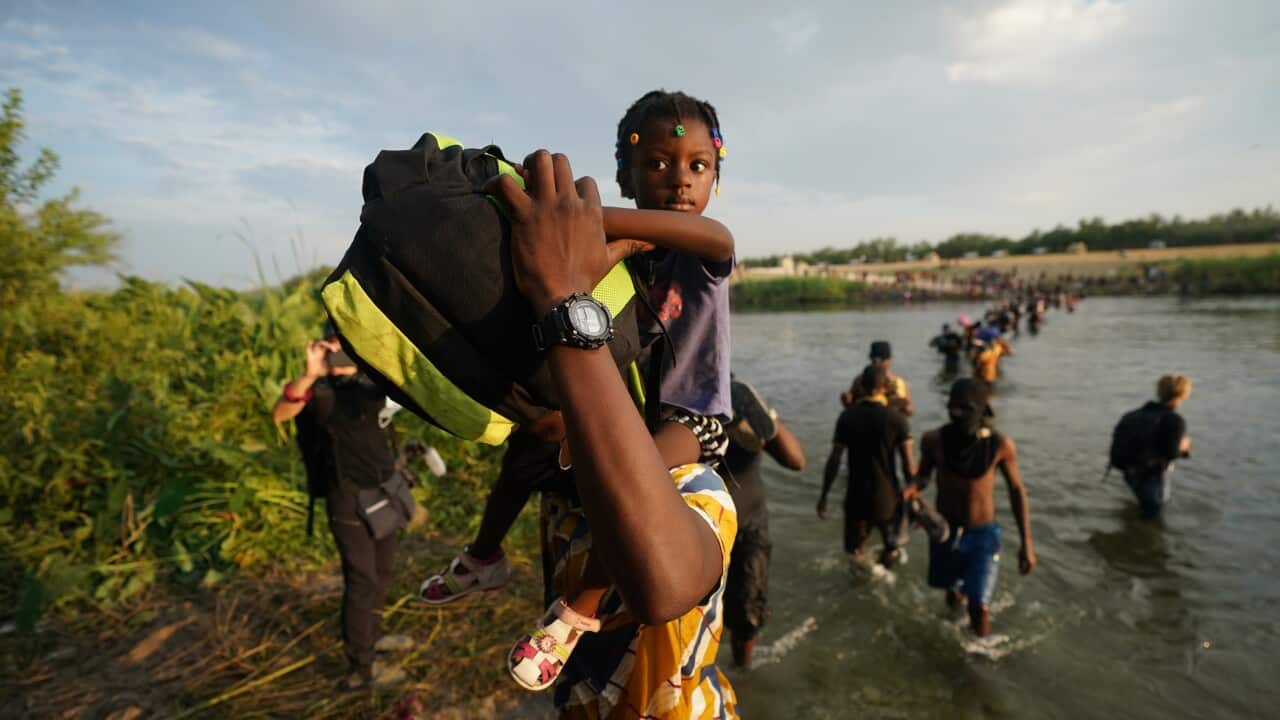 Migrants, many from Haiti, cross the Rio Grande from Del Rio, Texas, to return to Ciudad Acuna, Mexico, Tuesday, Sept. 21, 2021