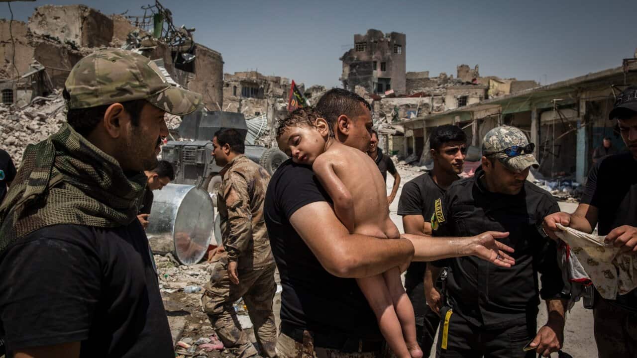 A boy being carried out of an area in Iraq that had been under Islamic State control.