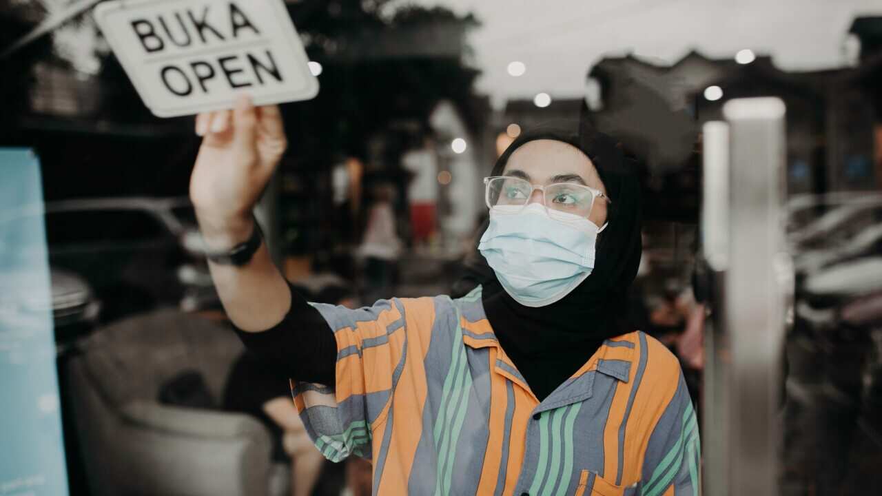 Open Sign For Small Business Owner At Work During Pandemic -