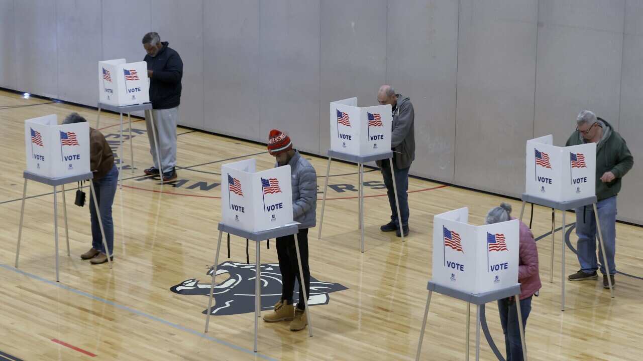 Voters cast their ballots inside a gymnasium in Michigan