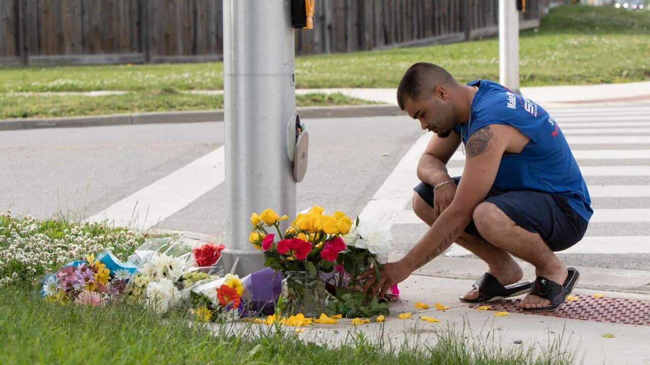 A man pays his respects at the scene where a pickup truck driver struck and killed four members of a Muslim family in London, Ontario, Canada on 7 June.