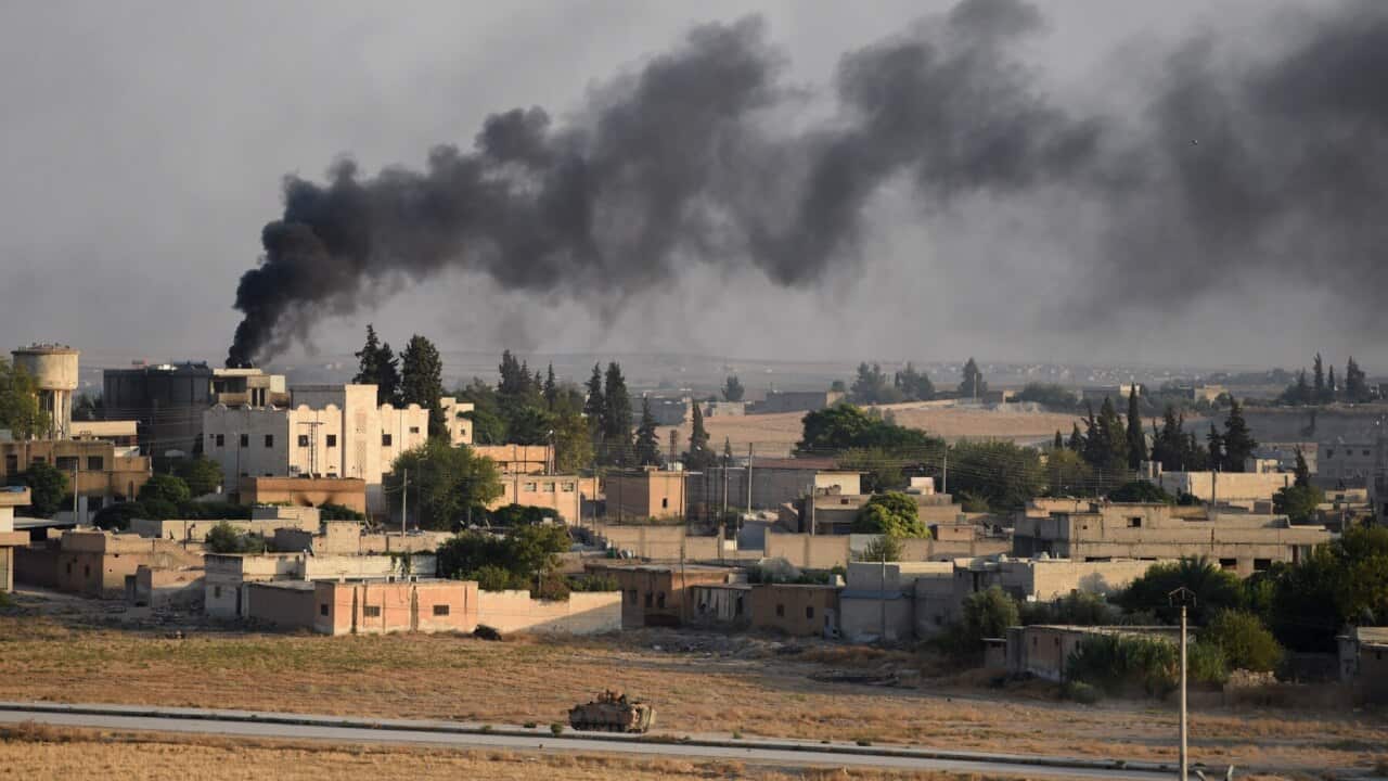 A Turkish army armoured vehicle advances in the Syrian city of Tel Abyad